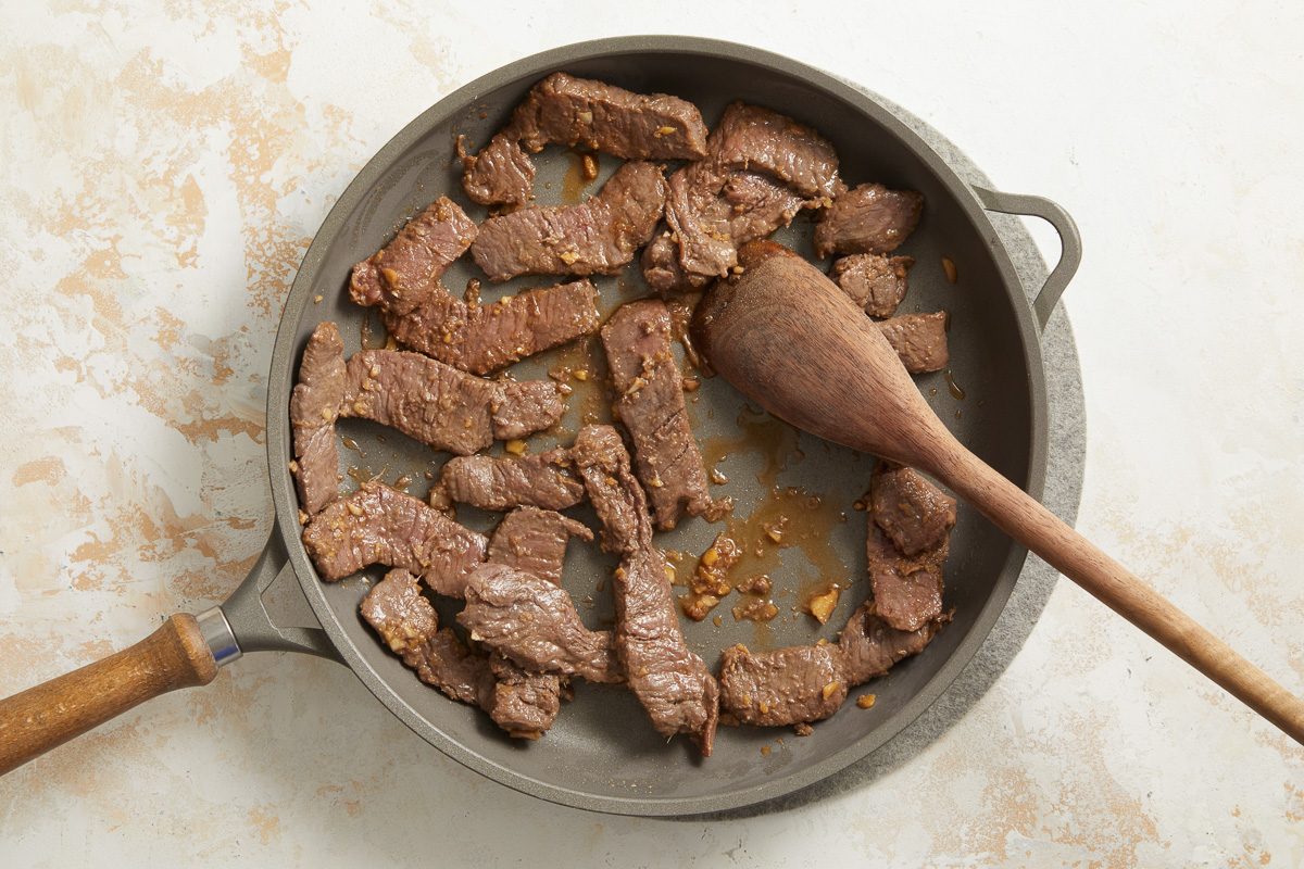 beef being cooked in a skillet
