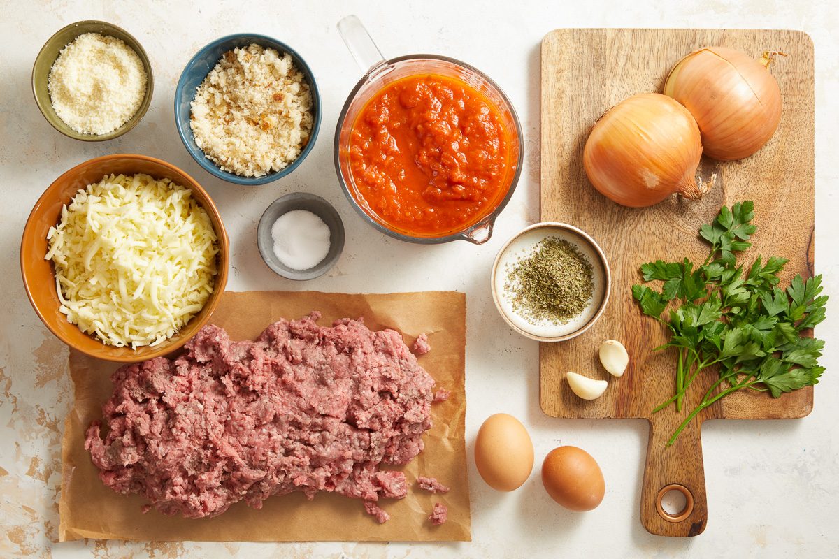 ground beef, eggs, onions, bread crumbs, parmesan cheese, garlic cloves, marinara sauce, salt, mozzarella cheese, parsley and Italian seasoning
