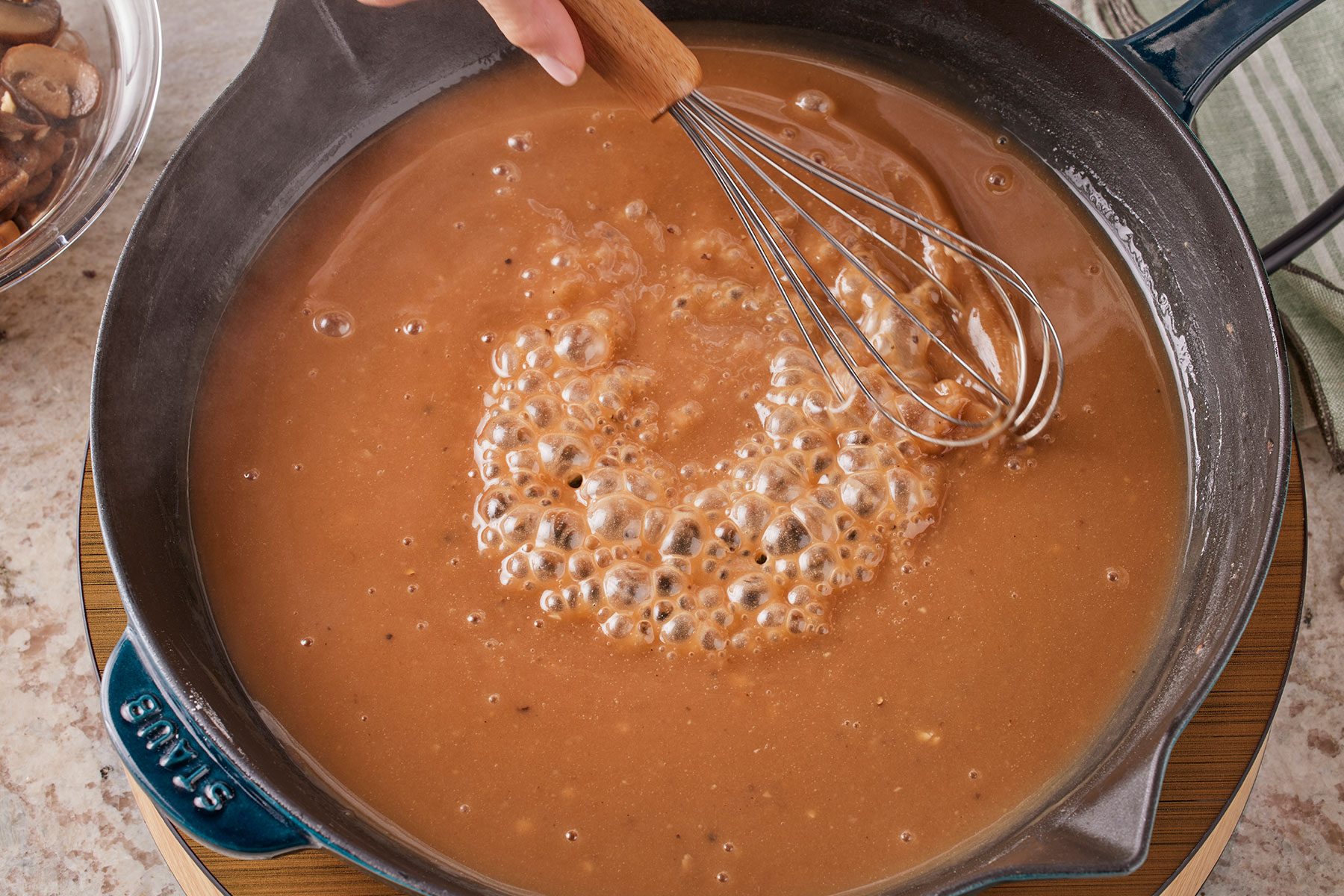 Stir in the beef broth, Worcestershire sauce, red wine vinegar, bouillon, salt and pepper and bringing to boil in a large skillet.