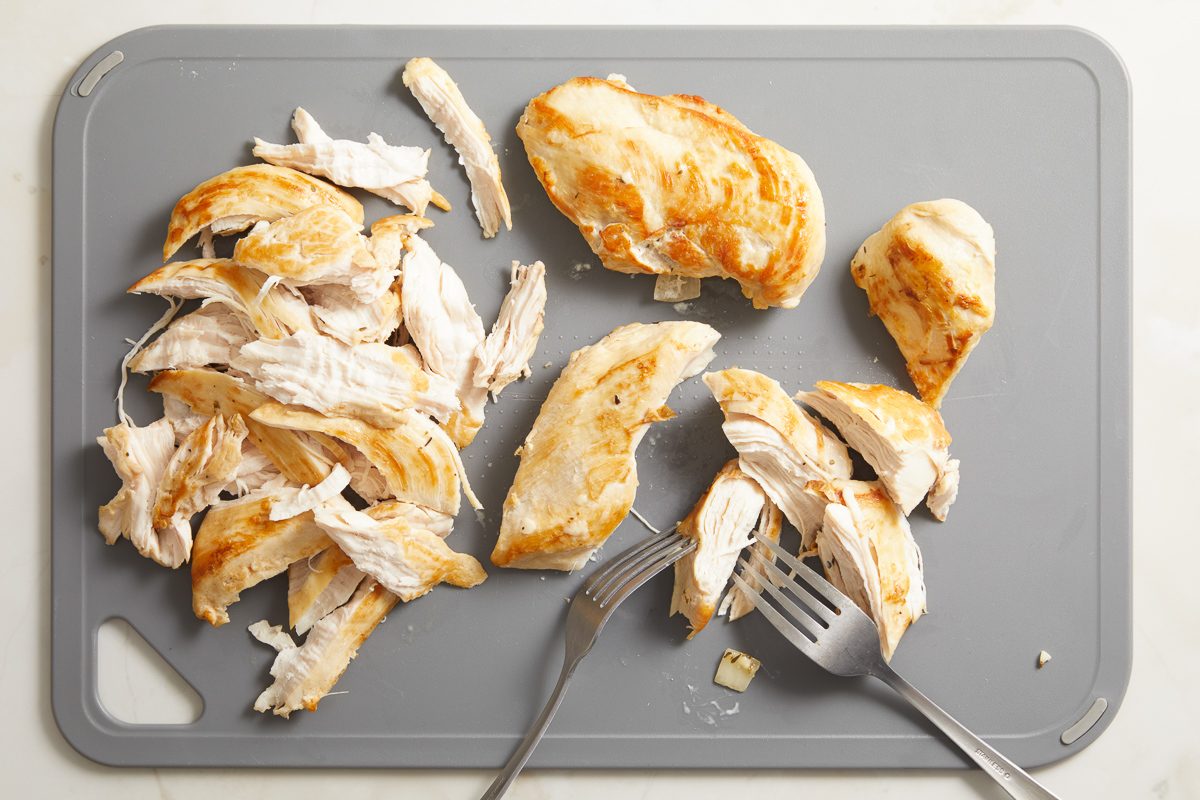 shredded chicken on. cutting board