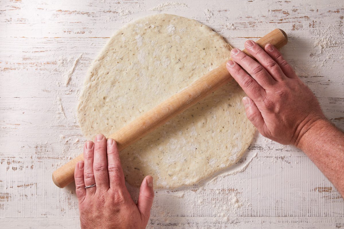 dough being rolled into a circle