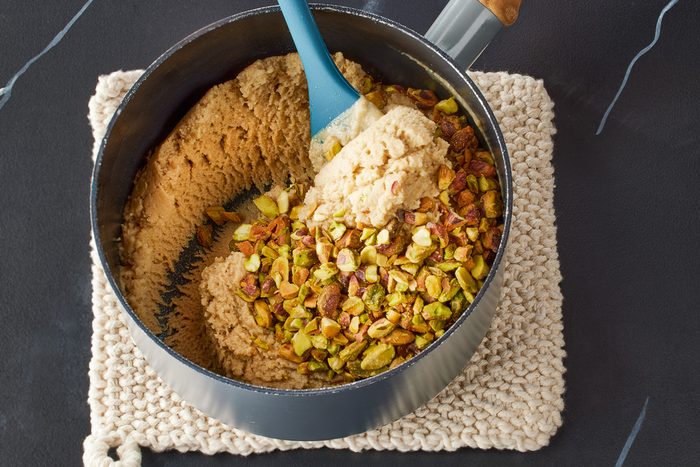 pistachios being folded in with tahini mixture