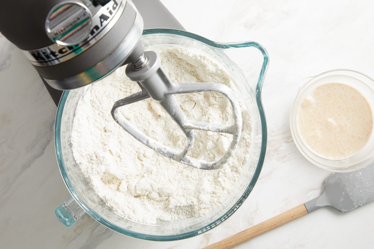 flour, sugar and salt being mixed in a large bowl