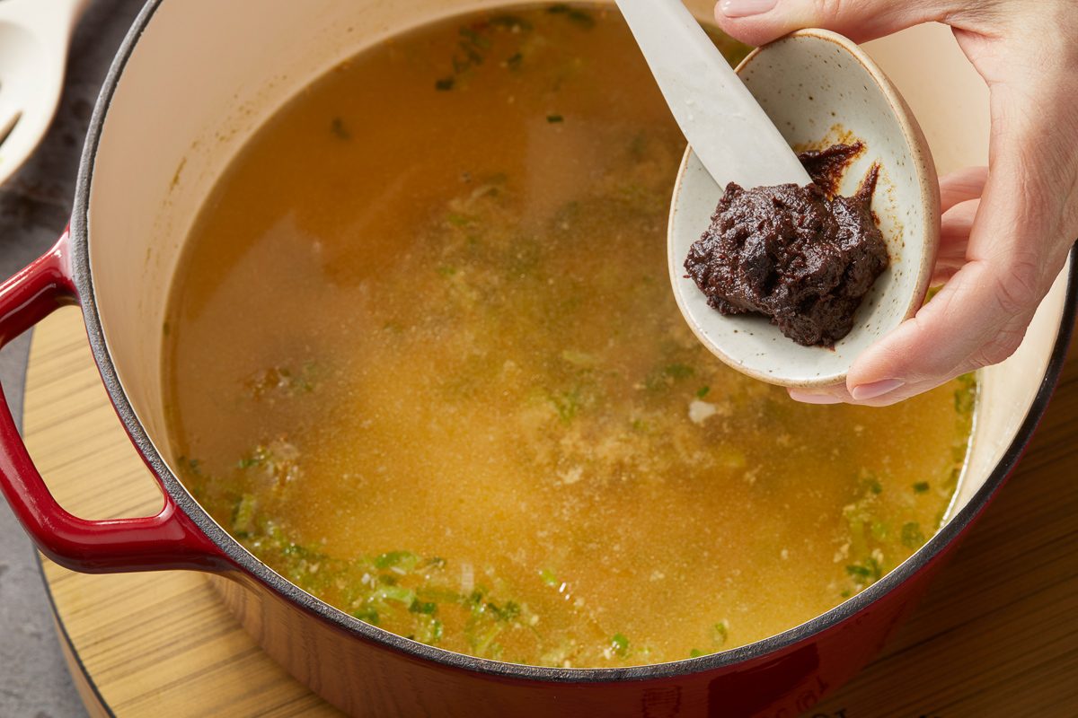 adding red miso paste to dashi