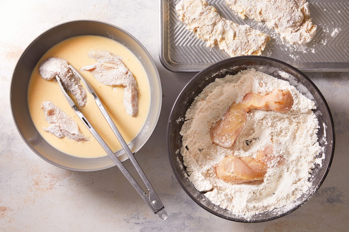 dredging chicken in flour then dipping in buttermilk mixture