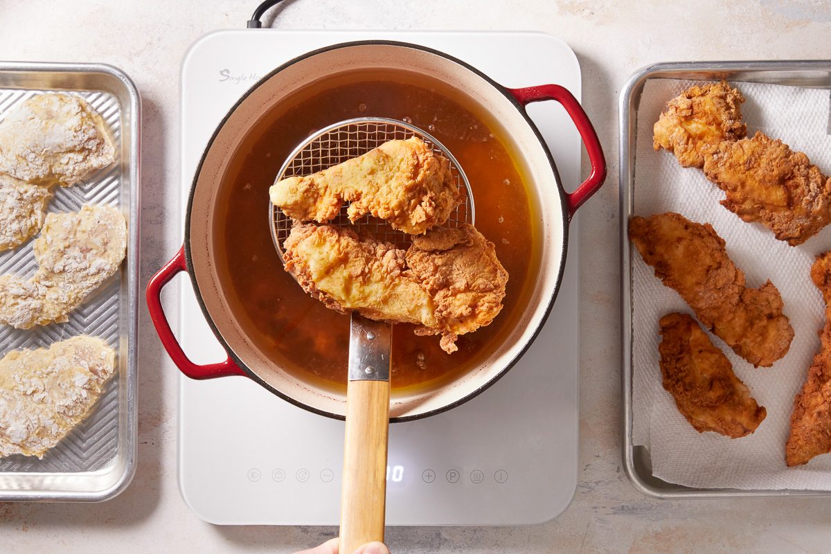 draining fried chicken