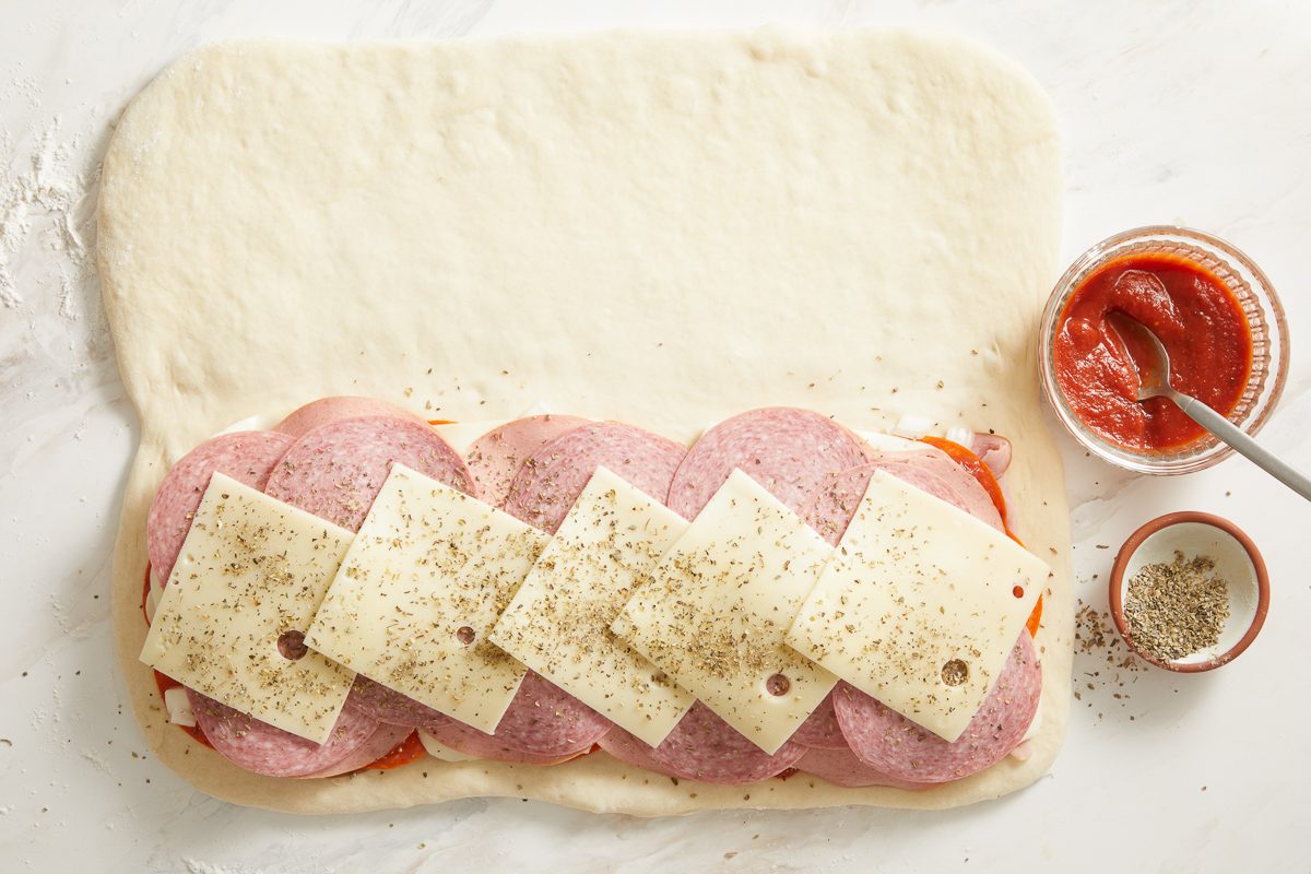 dried basil, oregano, garlic powder and pepper sprinkled over sliced mozzarella, bologna, salami and Swiss cheese