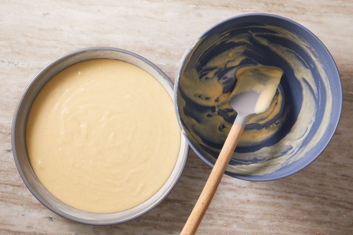 cake batter in a pan next to a bowl