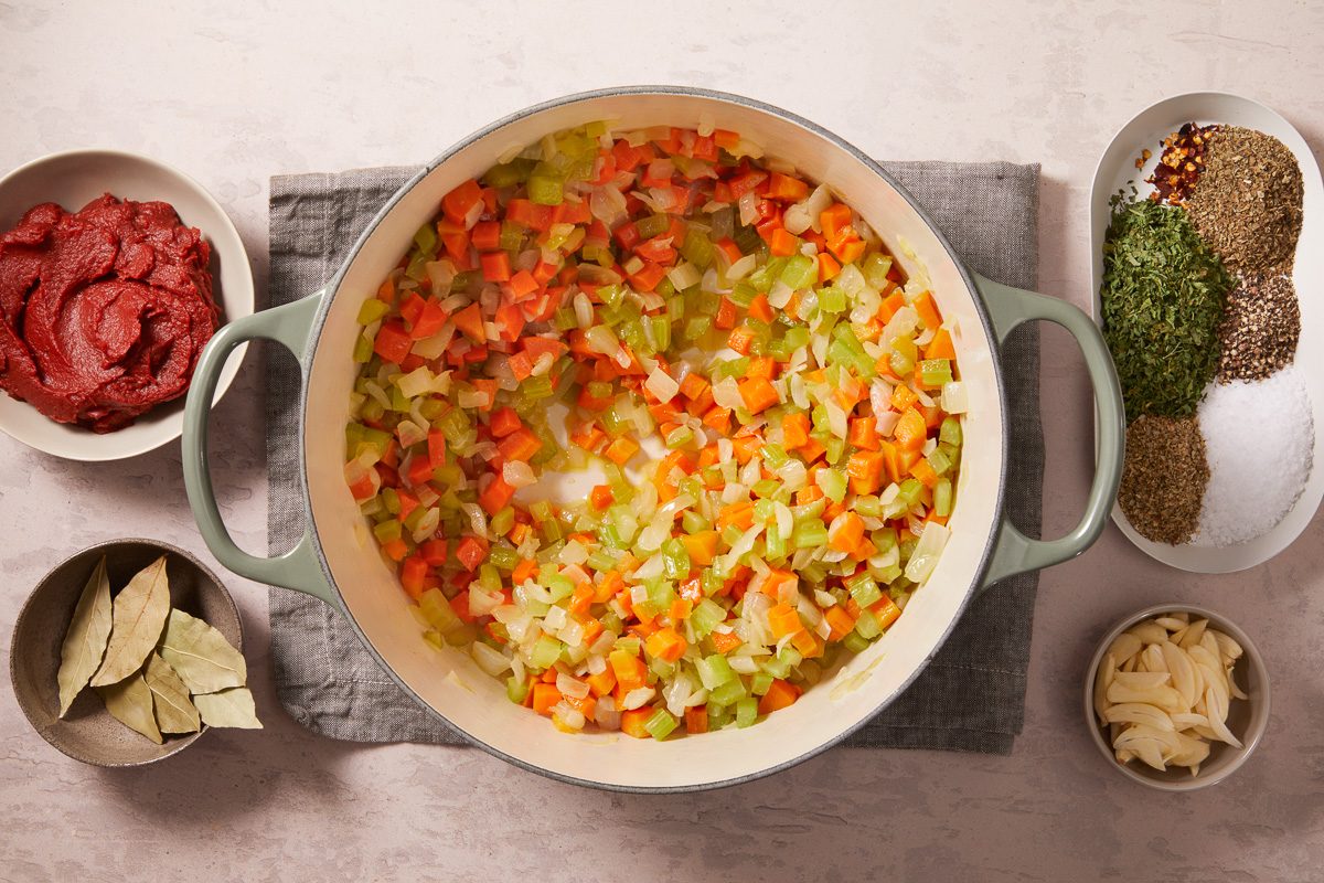 vegetables being sautéed in a large pot